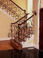 wrought iron interior rail with a mahogoney caprail